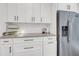 Close up on kitchen counter with stainless steel appliances and sleek white cabinetry at 1710 Sparkleberry Ln, Johns Island, SC 29455