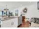 Open-concept kitchen island with stainless steel appliances and a view into the dining and living areas at 1710 Sparkleberry Ln, Johns Island, SC 29455