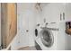 Well-lit laundry room with modern washer and dryer, plus built-in storage cabinets for convenience at 1710 Sparkleberry Ln, Johns Island, SC 29455