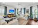 Bright living room with comfortable seating, hardwood floors, and modern decor at 1710 Sparkleberry Ln, Johns Island, SC 29455