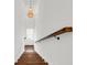 Stairwell with chandelier and dark wood handrail leading down to the lower level at 1710 Sparkleberry Ln, Johns Island, SC 29455