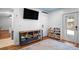 Spacious living room featuring white shiplap walls, blue ceiling, tv, wooden floors, area rug and storage shelving at 1725 Nantahala Blvd, Mount Pleasant, SC 29464