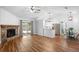 Bright open-concept living room featuring a stone fireplace, hardwood floors, and a view into the kitchen at 1725 Nantahala Blvd, Mount Pleasant, SC 29464