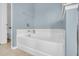 A soaking tub against blue walls features chrome fixtures, and white tile surround at 174 Dorothy Dr, Charleston, SC 29414