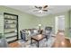 Comfortable living room featuring a sofa, recliner, wooden flooring, and stylish bookcase at 174 Dorothy Dr, Charleston, SC 29414