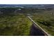 Breathtaking aerial view of a long wooden pier stretching across a marsh toward a distant highway at 1784 Omni Blvd, Mount Pleasant, SC 29466