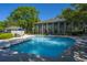 Community pool with lounge chairs, umbrellas, and a clubhouse in the background at 1784 Omni Blvd, Mount Pleasant, SC 29466