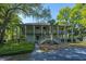 Two-story home with double balconies, lush greenery, and mature landscaping at 1784 Omni Blvd, Mount Pleasant, SC 29466