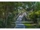 Winding pathway through lush greenery leading to a wooden bridge in the distance at 1784 Omni Blvd, Mount Pleasant, SC 29466