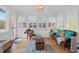 Bright sunroom with large windows, comfortable seating, and rustic decor at 1784 Omni Blvd, Mount Pleasant, SC 29466