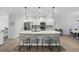 Elegant kitchen island with modern stools, pendant lighting, and stainless steel appliances at 187 Hayworth Rd, Summerville, SC 29486