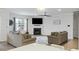 Bright living room featuring a cozy fireplace, plush sofas, a ceiling fan, and a large window with natural light at 187 Hayworth Rd, Summerville, SC 29486