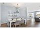 Bright dining area showcases elegant light fixture, table set for eight, and open kitchen view at 200 Pine Crest View Dr, Summerville, SC 29486