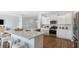 Gourmet kitchen features stainless steel appliances, white cabinets, and quartz countertops at 200 Pine Crest View Dr, Summerville, SC 29486
