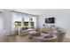 Bright living room features large windows, hardwood floors, and stylish contemporary furnishings at 200 Pine Crest View Dr, Summerville, SC 29486