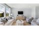 Bright living room features large windows, hardwood floors, and stylish contemporary furnishings at 200 Pine Crest View Dr, Summerville, SC 29486