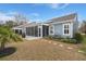 Grassy backyard featuring a screened-in porch and a landscaped yard at 2006 Barn Swallow Rd, Summerville, SC 29483