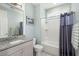 Clean bathroom with gray vanity, granite countertop, and shower-tub combination at 2006 Barn Swallow Rd, Summerville, SC 29483