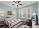 Cozy bedroom with a striped bedspread, ceiling fan, and natural light at 2006 Barn Swallow Rd, Summerville, SC 29483