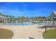 Spacious community pool area with plenty of lounge chairs, umbrellas and palm trees at 2006 Barn Swallow Rd, Summerville, SC 29483