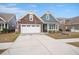 Charming single-Gathering home featuring a stone facade, two-car garage, and covered front porch at 2006 Barn Swallow Rd, Summerville, SC 29483