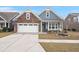 Charming single-Gathering home featuring a stone facade, two-car garage, and covered front porch at 2006 Barn Swallow Rd, Summerville, SC 29483