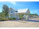 Charming white guardhouse with a metal roof and brick accents at the entrance to the community at 2006 Barn Swallow Rd, Summerville, SC 29483