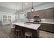 Modern kitchen blends seamlessly with the dining area, featuring an island, stainless steel appliances, and stylish finishes at 2006 Barn Swallow Rd, Summerville, SC 29483