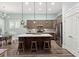 Beautiful kitchen featuring gray cabinets, stainless steel appliances, a large island and stylish pendant lighting at 2006 Barn Swallow Rd, Summerville, SC 29483