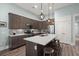Well-equipped kitchen features stainless steel appliances, gray cabinetry, quartz countertops, and an inviting central island at 2006 Barn Swallow Rd, Summerville, SC 29483