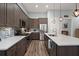 Modern kitchen with stainless steel appliances, gray cabinets, quartz countertops, and a stylish mosaic tile backsplash at 2006 Barn Swallow Rd, Summerville, SC 29483