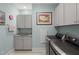 Functional laundry room with washer, dryer, sink, and ample cabinet space at 2006 Barn Swallow Rd, Summerville, SC 29483