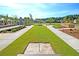 Picturesque lawn game area with horseshoe pits and bocce ball court in a beautifully landscaped community at 2006 Barn Swallow Rd, Summerville, SC 29483