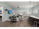 Open-concept living room and dining area with hardwood floors and plenty of natural light at 2006 Barn Swallow Rd, Summerville, SC 29483
