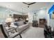 Open-concept living room with a ceiling fan, and seamless flow to the kitchen at 2006 Barn Swallow Rd, Summerville, SC 29483