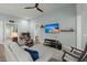 Bright living room featuring a comfortable sofa, ceiling fan, and entertainment center at 2006 Barn Swallow Rd, Summerville, SC 29483