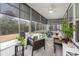 Bright sunroom with screened windows, comfortable seating, ceiling fan, and views of the backyard at 2006 Barn Swallow Rd, Summerville, SC 29483