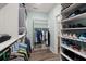 Organized walk-in closet with built-in shelving, hanging rods, and ample storage space at 2006 Barn Swallow Rd, Summerville, SC 29483