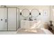 Modern bathroom featuring a double vanity, sleek black fixtures, frameless glass shower, and stylish round mirrors at 2010 Mcguire Ln # 003, Hollywood, SC 29449