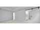 Bright bedroom featuring a sliding barn door to an en suite bathroom and neutral decor at 2010 Mcguire Ln # 003, Hollywood, SC 29449