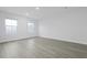 Minimalist bedroom with hard wood flooring and natural light from two windows at 2010 Mcguire Ln # 003, Hollywood, SC 29449