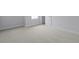 Bright bedroom features neutral carpet, white walls, baseboards, and trim with a large window and white door at 2010 Mcguire Ln # 003, Hollywood, SC 29449