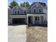 Two story home with a two car garage, light grey siding and a covered front porch with white columns at 2010 Mcguire Ln # 003, Hollywood, SC 29449
