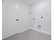 Bright laundry room features tile flooring, wire shelving and hookups at 2010 Mcguire Ln # 003, Hollywood, SC 29449