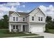 Charming two-story home with a welcoming front porch, attached two car garage and well-manicured lawn at 2014 Mcguire Ln # 004, Hollywood, SC 29449