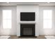Modern living room featuring a fireplace with mounted TV and large windows for natural light at 2018 Mcguire Ln # 005, Hollywood, SC 29449