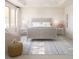 Serene bedroom with neutral tones, a large window, stylish rug, and a tray ceiling at 2022 Mcguire Ln # 006, Hollywood, SC 29449