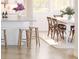 View of kitchen island with barstool seating; dining table and chairs in background at 2022 Mcguire Ln # 006, Hollywood, SC 29449