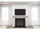 Living room featuring a fireplace with a mounted TV and bright windows at 2022 Mcguire Ln # 006, Hollywood, SC 29449
