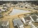 Aerial view of a neighborhood featuring a pond and well-maintained homes with manicured lawns at 203 Goldfinch Ln, Summerville, SC 29485